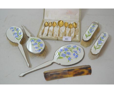 Five piece silver backed and enamel decorated dressing table set (one brush at fault) and a silver mounted comb, together wit