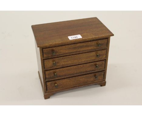Miniature 20th Century mahogany four drawer chest with bracket feet, 9ins wide 