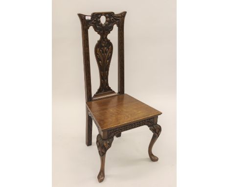 19th Century oak side chair with carved splat back, panel seat and cabriole carved front supports 