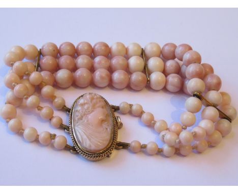 Victorian triple row angel skin coral bead bracelet, the oval clasp inset with carved cameo angel skin portrait (one row deta