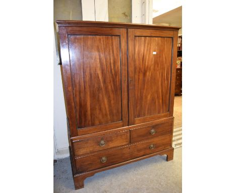 19th Century mahogany low linen press, having moulded top above two panelled doors, two short and a single long drawer with b