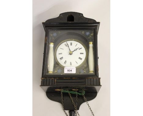 19th Century Continental ebonised cuckoo clock, the circular enamel dial with Roman numerals, flanked by porcelain pilasters 