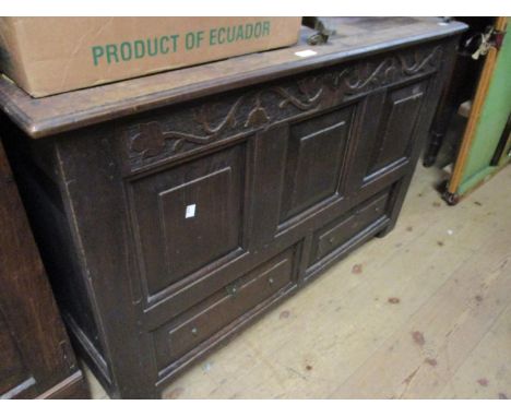 18th Century oak mule chest, the hinged three panel lid above a carved frieze, three panel front and two drawers on stile sup