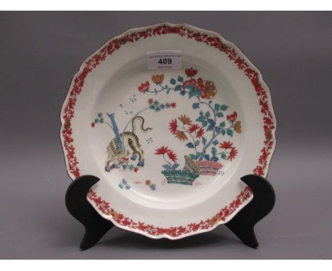 18th Century Worcester plate decorated in the Kakiemon palette with Korean tiger pattern within an iron red and gilt floral b