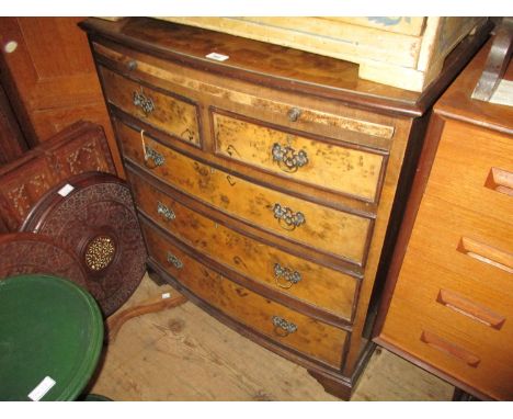 Mid 20th Century figured walnut bow front chest with a pull-out slide above two short and three long drawers with brass handl