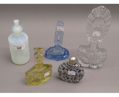 Sabino opalescent glass perfume bottle decorated in relief with figures, a blue glass and metal mounted perfume bottle and th