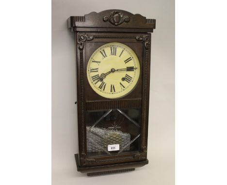 Early 20th Century Continental beechwood rectangular wall clock, the painted dial with Roman numerals and two train movement 