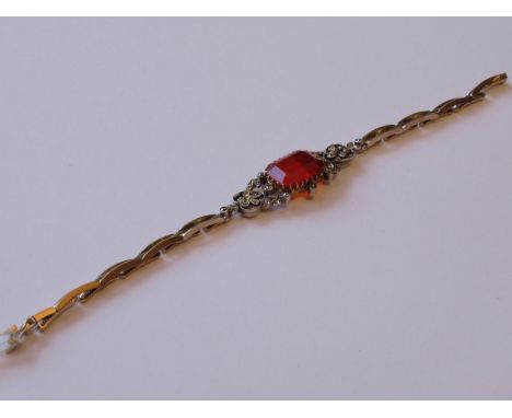 Edwardian large fire opal and diamond set bracelet of pierced design, the opal approximately 15mm x 10mm, 13.2g 