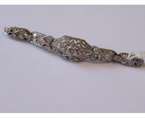 Art Deco platinum and diamond set bar brooch of pierced design, 8.2g, 66mm wide 