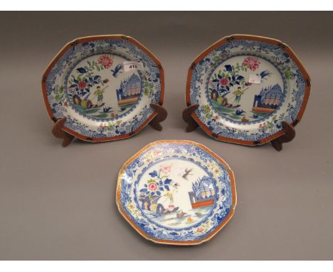 Derby octagonal plate painted with figure in a punt before a palace of Oriental style within an iron red and gilt border, 8.5