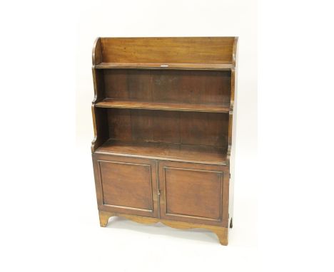 19th Century mahogany waterfall bookcase with three open shelves above two panelled doors on bracket feet, 32ins wide, 45.5in