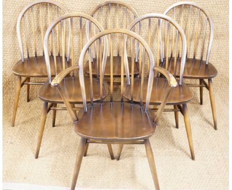 A set of six Ercol Windsor style dining chairs comprising five standard and one arm chair, together with a similar Ercol dini