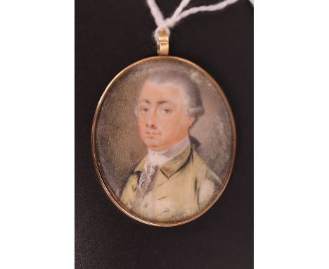 A George III wedding pendant or love token, obverse a portrait miniature of a bewigged gentleman in stock and yellow frock co