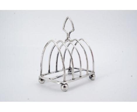 An Edwardian silver toast rack, of arcaded form, Harrison Brothers and Howson, Sheffield, 1907, 101.5g