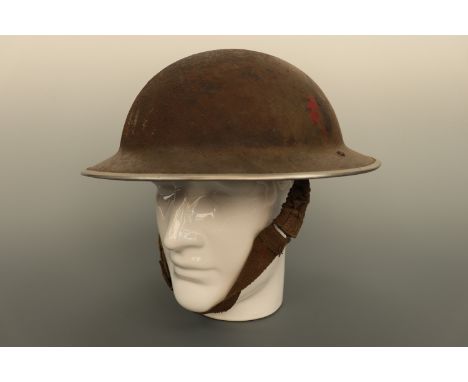 A Second World War British army or Home Guard steel helmet bearing a circular formation sign and stencilled initials "HQ" or 