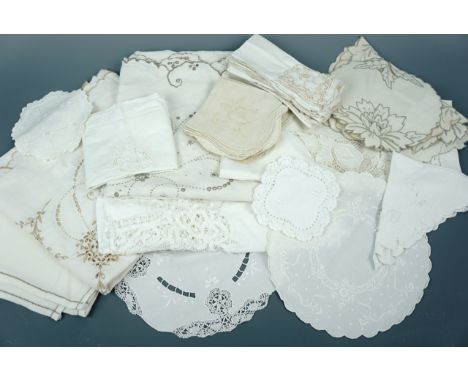 A quantity of vintage hand and machine embroidered table linens, in neutral tones, comprising table cloths, napkins and mats,