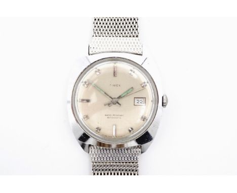 A 1960s Timex automatic wristwatch, having a chromium plated water resistant tonneau shaped case, the circular brushed silver