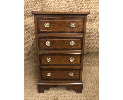 A Georgian-influenced mahogany besdside chest, having brass ring handles. 43 cm x 33 cm x 75 cm
