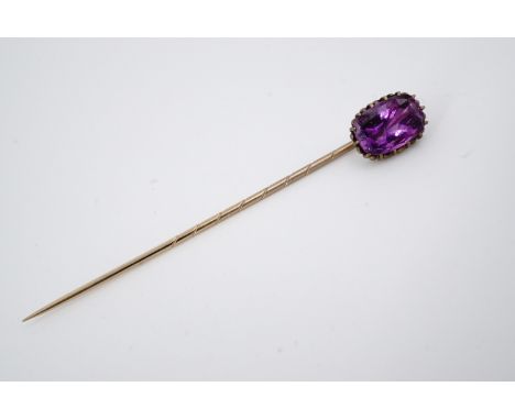 An antique pink sapphire and rose yellow-metal stick pin, the faceted cushion-cut stone of approximately 10 x 8 mm and 3.1 ct