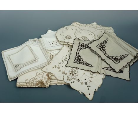 A quantity of vintage neutral toned hand-embroidered table linens, including an Edwardian tea table cloth with matching napki