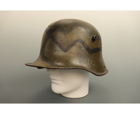 An Imperial German Model 1916 steel helmet bearing Ludendorff mimikri camouflage