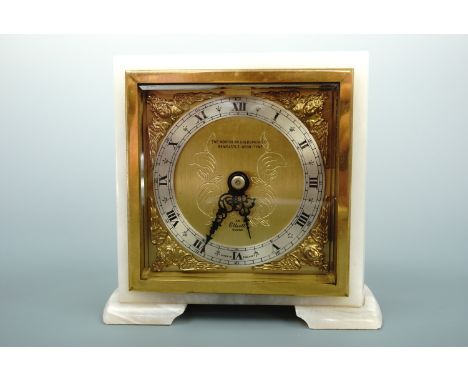 An Elliott white onyx mantle clock retailed by the Northern Goldsmiths of Newcastle-Upon-Tyne, having a gilt brass face with 