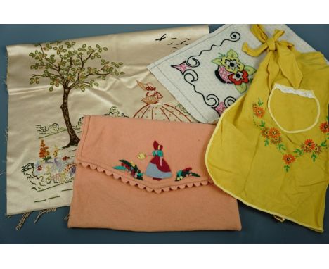 Vintage needlework items including yellow cotton half-apron embroidered with flowers, a peach felt pyjama case decorated with