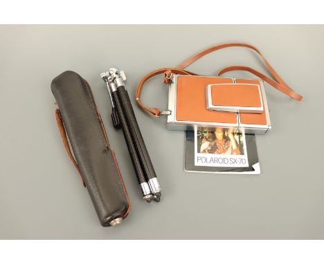 A 1960s Polaroid SX-70 Alpha folding Land camera, or self-developing instant film camera, with tripod and original manual