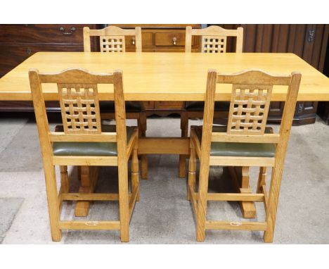 A Beaver Furniture oak dining suite, comprising an adzed oak table with two extension leaves and four lattice-back chairs, (r