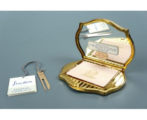 A 1950s Stratton "Initial" powder compact, the engine-turned case having a pair of apertures framing key-adjustable dials bea