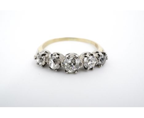 An antique five-stone diamond ring, comprising a subtly tapering setting of old cut diamonds, the central stone of approximat