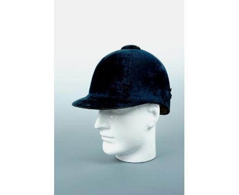 A lady's antique dark petrol blue velvet riding helmet retailed by "Herbert Johnson, 38 New Bond Street, London", 16 x 21 cm 