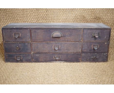 An early 20th Century clerk's pine chest of drawers, 80 cm x 28 cm