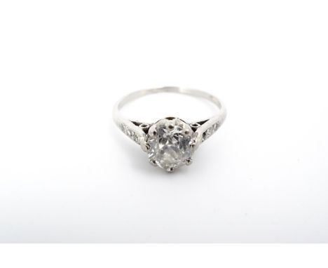 A vintage diamond solitaire ring, the brilliant-cut diamond of approximately .80 ct, flanked by three graded diamonds to each