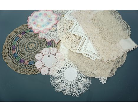 A quantity of antique and vintage doilies and antimacassars, worked in white and pastel colours