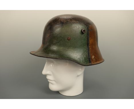 An Imperial German Model 1916 steel helmet bearing Ludendorff mimikri camouflage