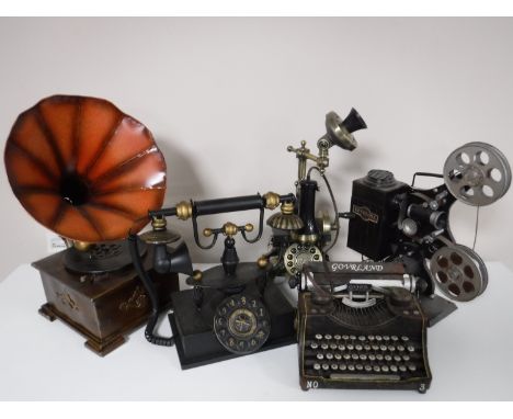 Five contemporary metal ornaments including Keystone projector, Govrland typewriter, telephone, gramophone etc 