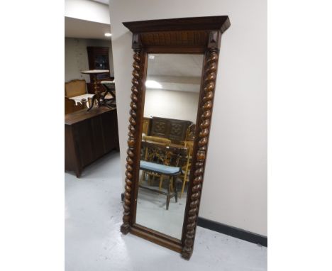 An antique oak dressing mirror with barley twist supports 