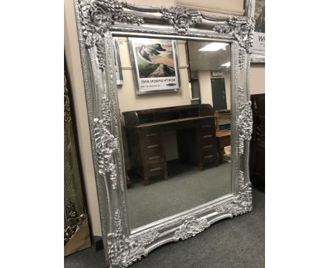 An ornate silvered mirror, 123 cm x 155 cm. 