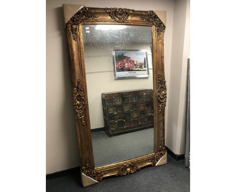 A large gilded ornate framed mirror, 125 cm x 214 cm. 