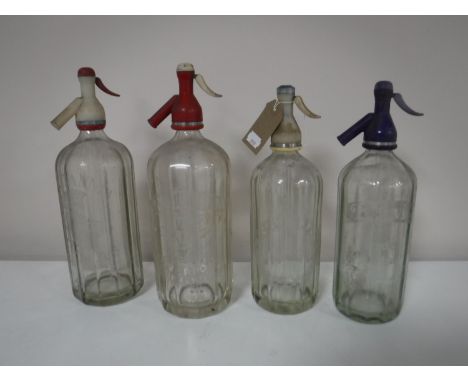 Four vintage glass soda siphons bearing advertising Schweppes, Brittvic etc 