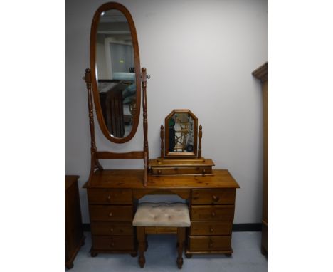 A pine eight drawer knee hole dressing table with mirror and stool plus a cheval mirror 