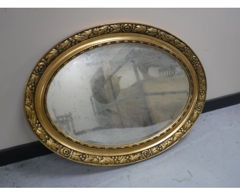 An early 20th century oval gilt framed bevelled edge mirror