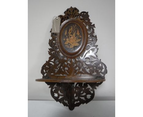 A Victorian inlaid mahogany fretwork wall shelf