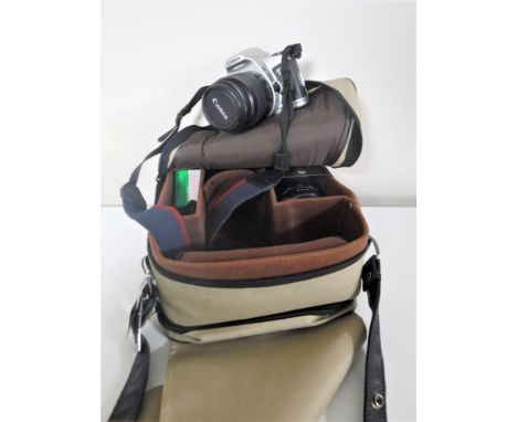 A Canon EOS 500 camera with two lenses together with a camera case
