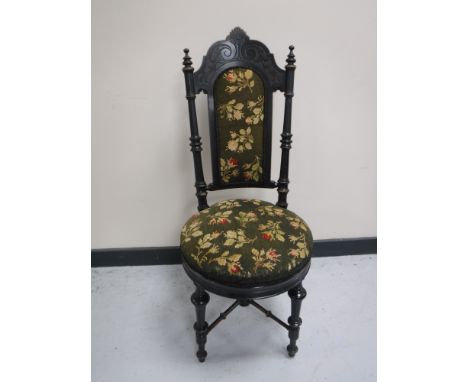 A carved ebonised hall chair in a floral tapestry fabric