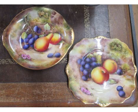 R Budd, a circular plate and a square plate decorated with fruit to a mossy background