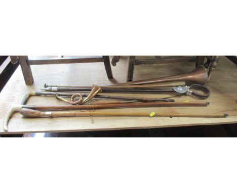 A collection of canes, hunting horns etc, some with silver collars