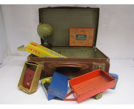 A vintage leather suitcase with mixed toy contents including Meccano motors, tinplate tipping trailer, Chad Valley tinplate g