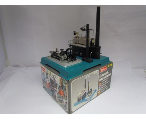 A boxed Wilesco D18 live steam Dampfmaschine stationary engine, horizontal boiler on tinplate brickwork effect plinth with ch